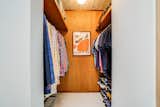 The primary closet’s original dropped ceiling was removed during the renovation in order to add height to the space. New mahogany paneling and custom millwork complete the transformation.
