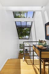 Large, slanted skylights above the stairwell funnel light into the space.