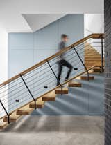 The stair design and handrail borrows from the original midcentury dwelling, while the blue fulcrum core guides ascension to the second level.