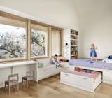 Generously-proportioned windows, framed by a wood soffit, funnel light into the kids bedroom.