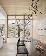 Window divisions were inspired by the mullion patterns of the original home. "This expression of the mullions allows them to become a bit like looking out through the site’s tree trunks, which dissolves the interior and exterior division," says architect Sarah Johnson.