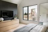 In the bedroom of a residential unit, carefully positioned openings frame views of Misco Mill.