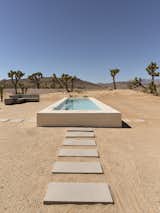 In addition to the redesigned main house, Mila Morris’s Yucca Valley residence includes a tiny home, studio, and pool. Since much of the lot’s acreage sloped down into the canyon, some of the land was flattened to add the pool, along with a concrete bench designed by Mila.