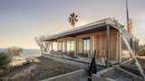 This Connect 4 showcases panoramic ocean views in Malibu, California. A recovery effort after the Woolsey Fires, the home was craned in and carefully positioned on the coastal site — photo is taken at the end of install day. Connect Homes built five homes for Malibu homeowners after the fires, including a Connect 10 that was the first home back online.  Photo 8 of 12 in Our Top Ten Prefab Homes From Connect Homes