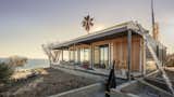 This Connect 4 showcases panoramic ocean views in Malibu, California. A recovery effort after the Woolsey Fires, the home was craned in and carefully positioned on the coastal site — photo is taken at the end of install day. Connect Homes built five homes for Malibu homeowners after the fires, including a Connect 10 that was the first home back online.