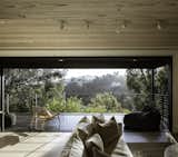 The great room of this Brentwood, California, guesthouse showcases jaw-dropping views of the surrounding tree canopy. The entire 40-foot span of the Connect 2 is turned into a wall of glass, an architectural maneuver made possible by the high-strength steel perimeter frame  built into all Connect Homes.