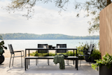An inviting lakeside dining grouping pairs the timeless Alfresco Dining Table with chairs and a bench from the collection—both which can be customized with Sunbrella ® cushions for added style and comfort.