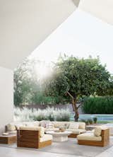Warm teak and creamy ivory upholstery give the Batten Outdoor Collection an air of casual luxury.