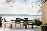 An inviting lakeside dining set pairs the timeless Alfresco Dining Table with chairs and a bench from the collection—both which can be customized with Sunbrella ® cushions for added style and comfort.
