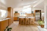 Light pours into the renovated kitchen from all directions, with a new natural palette making the room a warm and inviting family space. Leah replaced the dated floors throughout the home with Hakwood engineered European oak in a finish called Aura.