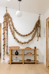 Several handcrafted pieces by local artist Jim Olarte adorn the home, including this macrame installation in the entry, made using old fisherman’s rope he found on the beach. "It’s cool seeing him take what was once waste and reuse it for something one-of-a-kind and so beautiful," says Leah.