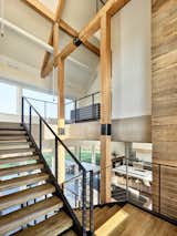 Inside, a stair tower features a venting skylight—funneling light into the home and allowing passive ventilation. "The interior is a celebration of the building’s construction, displaying how it’s built without fear of degradation by natural forces," says Coyle of the home’s exposed building elements.
