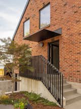 On the home’s east facade, a steel canopy protects the reoriented entry.