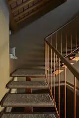 Carpeted stair treads follow the gentle curve of a solid oak handrail. The home’s interior surfaces are rich, warm, and tactile. “The floors and walls are finished in such a way that you will want to stroke them forever, as long as you can actually touch them,” says Nakamura.