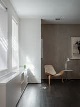 Dark-stained wide plank walnut floors run cohesively throughout the apartment. The original concrete walls were exposed to provide a counterpoint to the existing rustic wood columns.