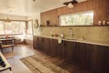 The revamped kitchen features custom walnut cabinetry by Stille Home—all made from a fallen walnut tree from Leah and Kyle’s last project. All of the home’s cabinets and custom built-ins were the result of a close collaboration between Leah and Kyle. “It’s rare to find a builder who can instantly understand the wild ideas in my head, and bring them to life even more beautiful than I imagined,” says Leah.