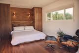 The primary bedroom features a built-in walnut bed handcrafted by Kyle (Stille Home).