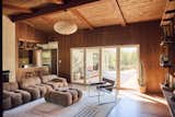 The living room features a pendant from Ochre and Silk, barstools from Hati Home, and a wool rug from Revival. The European Walnut floors throughout the home are Stuga “Zig Zag.”