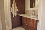 While Leah and Kyle were unable to expand the compact primary bathroom, a skylight was added when the roof was replaced. “By adding a skylight and beautiful tile, we made it feel like a little spa even with it being a small footprint,” says Leah. Tile selections from Zia Tile include Apollo 12x12 for the floors and countertop, and Dune 4x4 for the shower walls.