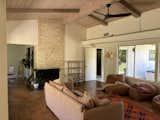 The 1965 home, pictured before the renovation, had seen only light cosmetic changes over the years—like the tile on the fireplace, which was most likely added in the 1990s. “Inside, the ceilings were beautiful, but the flow was all off and the kitchen felt so closed off from the living space,” says Leah of the original home.
