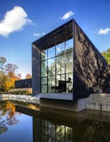 A two-story commercial glass and aluminum window is reflected in the property’s pond. The ends of the home taper to form a "knife edge" profile, making the walls appear paper thin. "The detail is more than a detail—it’s a space-defining element," says Höweler.