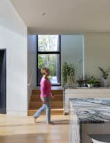 The kitchen, by design, is at the center of the "plus," where the home’s two intersecting volumes overlap. The four first floor wings include a living room, dining room, primary bedroom suite, and entry foyer with power room and gym. The upper floor consists of three bedrooms, all en suite, for the couple’s three daughters.&nbsp;