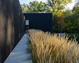 "The black char looks flat from a distance, but up close you see the texture and pattern of the wood," says Höweler. "The char also catches the light and has a luster that shimmers."