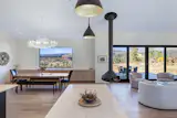 The convergence of space inside reflects the convergence of landscape outside, with the great room being one of the clients’ favorite areas of the home. "While the space accommodates distinct functions—kitchen, dining, living, and entertaining—it ultimately reads as a cohesive whole," says homeowner Bill Joost. "We particularly appreciate the sense of continuity."
