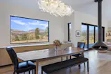 Through the home’s design, views remain the primary focus. A relatively shallow plan, along with carefully-placed doors and windows help funnel light deep into the interior spaces. Facing north, expansive 180-degree views can be enjoyed from the living and dining rooms, where a large picture window frames the stunning natural landscape.