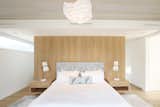 A White Oak Built-In Headboard Wall and Floating Nightstands in the Master Bedroom