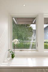 Wall-to-Wall Windows at the Kitchen Create a Light and Bright Space