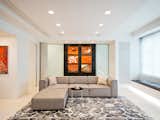 Living Room, Sofa, Rug Floor, End Tables, Light Hardwood Floor, Bench, and Recessed Lighting Wall-to-wall Window Bench Provides Storage, Glass Pocket Doors Conceal TV Room  Photo 8 of 20 in Upper West Side Apartment by Resolution: 4 Architecture