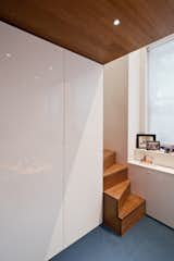 Glossy White Full Height Cabinets Provide Storage and a Counterbalance to the Rich Woods