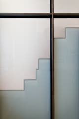 Translucent Wall Panels Allow Daylight and Project a Profile of the Quirky Alternating Tread Stair