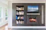 TV Room Fireplace with Black Steel Surround and Bookshelves