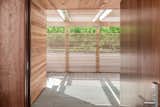 New Front Door to Main House under Cedar Trellis and Behind Slatted Screen Wall