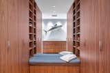 Dressing room with custom walnut built-ins.