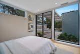 The guest bed looks out past the pool deck and pool to the dunes.  Photo 14 of 24 in Whalers Residence by Resolution: 4 Architecture