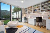 The office includes a custom desk built-in and a small pull out sofa on the opposite side, so it can double as a guest room.