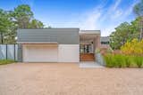 Approach from autocourt with site-built garage and covered breezeway entry.