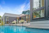 The dining deck off the living space looks past the pool to the dunes.