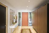 The formal foyer, entered from the covered walkway, is geared towards guests. The built-ins here were the only ones in the home viable for salvage, and were retained from the original design.