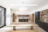 The kitchen space opens to a new family room that flanks the end of the pool deck with a wall of sliding glass doors.