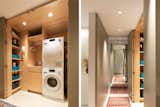 Similarly, a laundry closet has double millwork doors that read as full height, floor-to-ceiling panels when closed. When open, though a room, the interior reads as another cabinet with pre-finished maple built-ins, including the one special request from the owners a pull-out ironing board drawer.