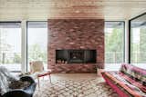 A traditional brick fireplace surround includes a wood-burning stove insert in the living room.