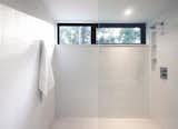 A high window in the large shower provides views of the woods while maintaining privacy.