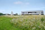 Main residence and pool house/garage seen from south meadows.