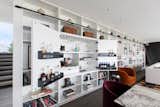 Built-in bar cabinet hidden within library wall.