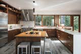 The Engbergs' kitchen, with its slate floors and black walnut cabinetry, looks out to an adjacent forest woodland
