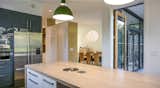 In the kitchen, where fresh air flows continuously in Oregon's mild climate, Ikea cabinetry helped keep costs  down, while the same maple surface was used for an island and flooring to achieve visual clarity.  Photo 1 of 9 in Budget Breakdown: An Architect Couple Build a Net-Zero Home and Studio for $250 Per Square Foot